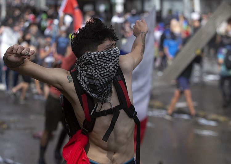 Manifestante chileno enfrenta tropas do governo: "Piñera não deve governar"